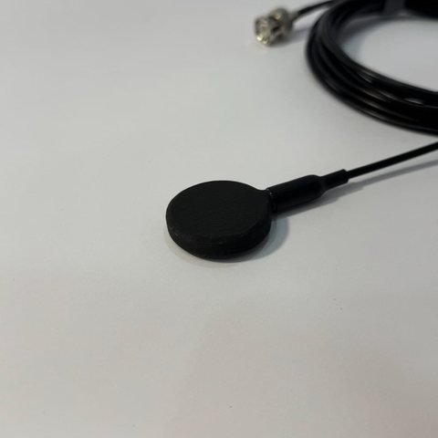 AquaHear 1.0 hydrophone, a 32 mm disc on a coiled black cable.